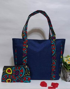 Dark denim African hand Bag with a straps for both hand and shoulder. Sewn with kitenge to the sides with extra mini bag.