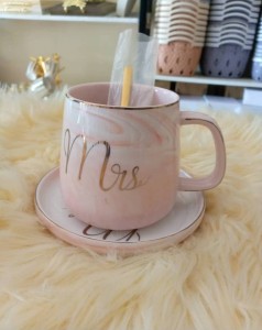 Tea cup with it's tray and spoon. pinkish color