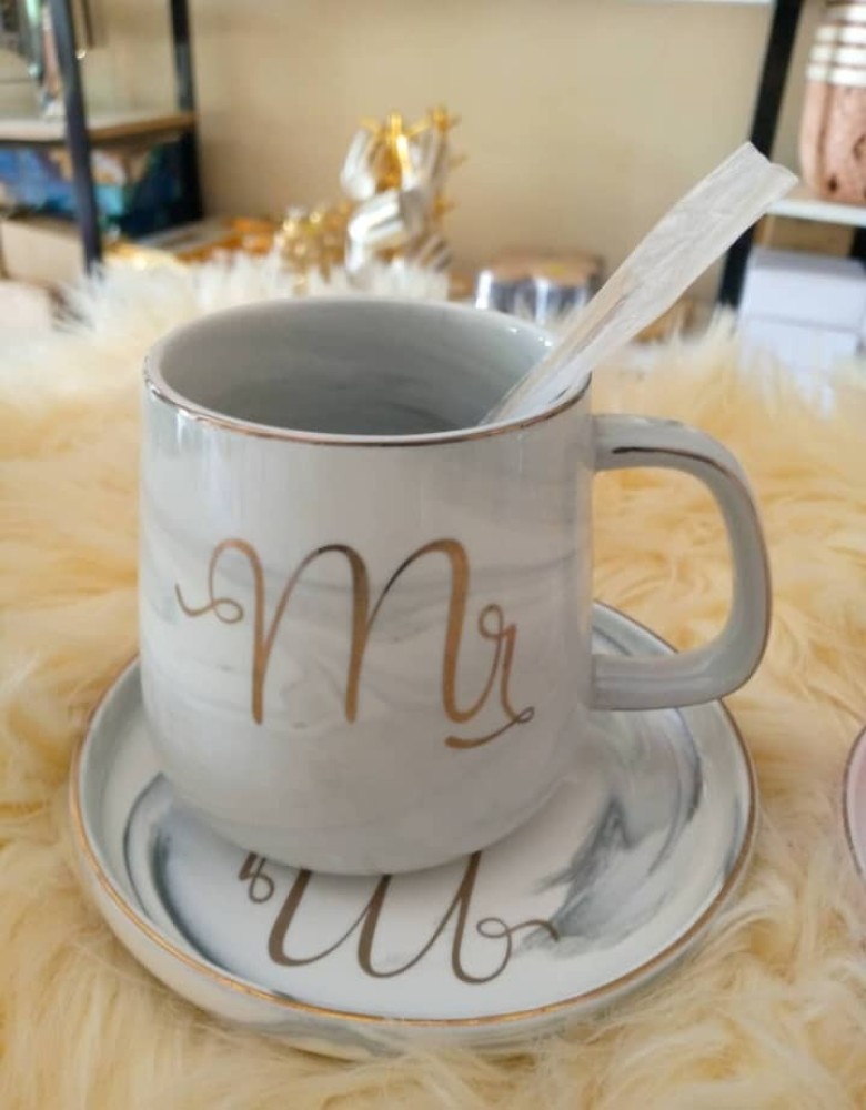 Tea cup with it's tray and spoon. Grey color