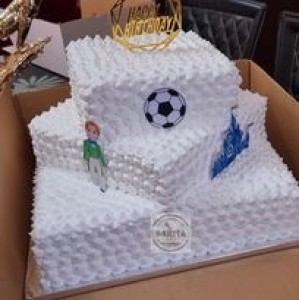 Football cake decorated with white cream and eatable football picture