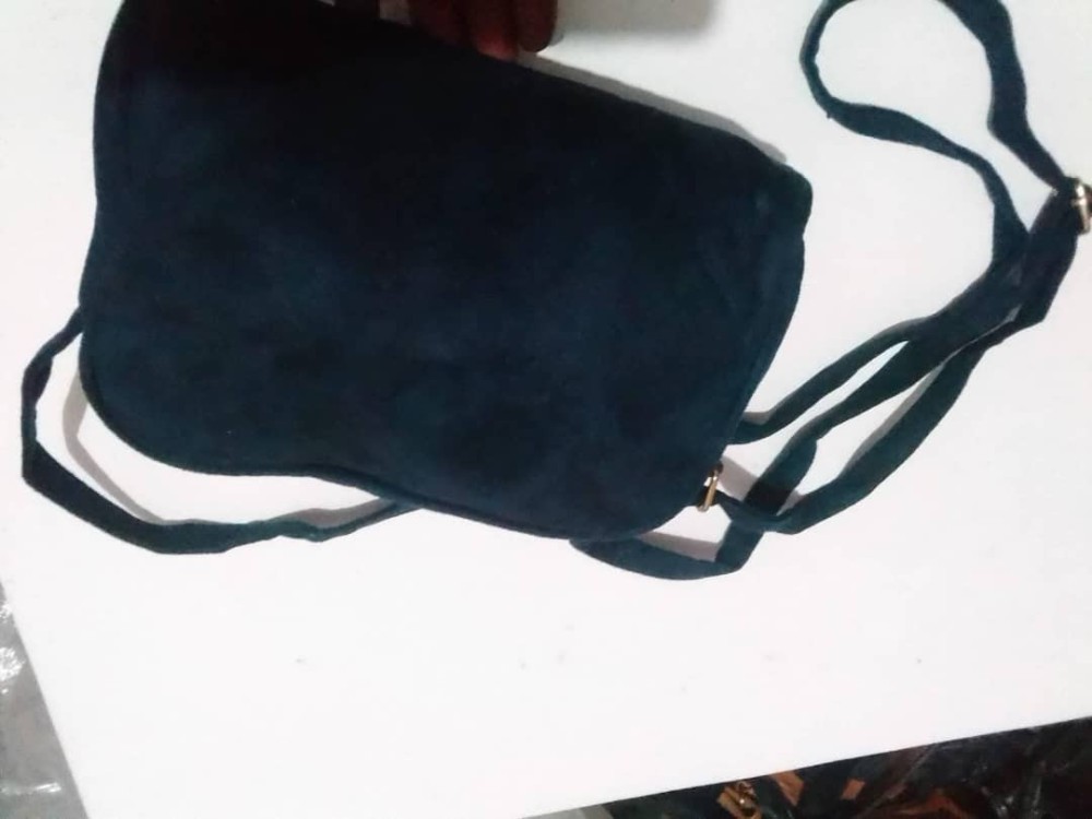 Dark blue hand bag with a slim strap for both hand and shoulder holder.