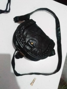 Black hand bag with a slim strap for both hand and shoulder holder.