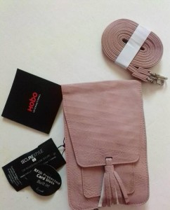 Pink hand bag with a slim strap for  shoulder holder. it's a most for phones and smaller items.